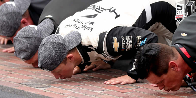 AJ Allmendinger and Matt Kaulig kissing the bricks