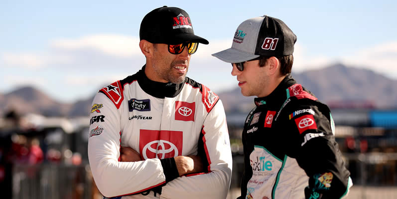 Aric Almirola and Chandler Smith talk on the grid during practice