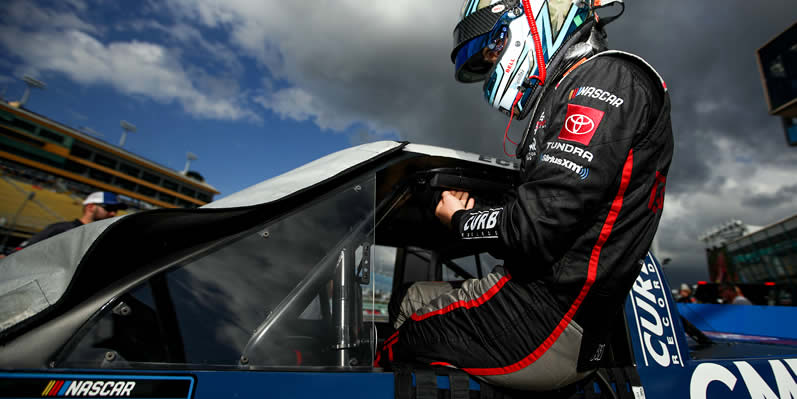 Christian Eckes enters his truck during practice