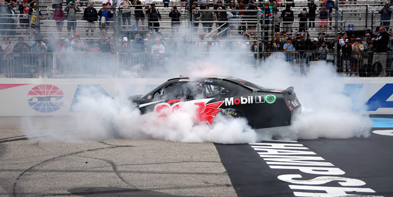 Christopher Bell celebrates with a burnout