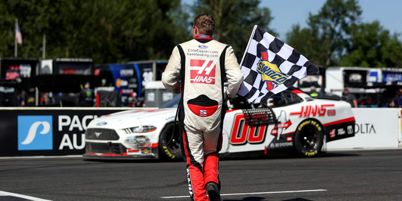 Cole Custer celebrates with the checkered flag