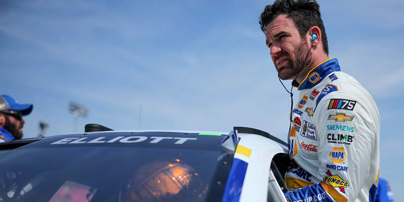 Corey LaJoie enters his car during qualifying