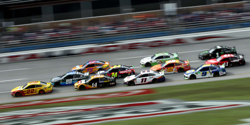 Joey Logano leads a pack