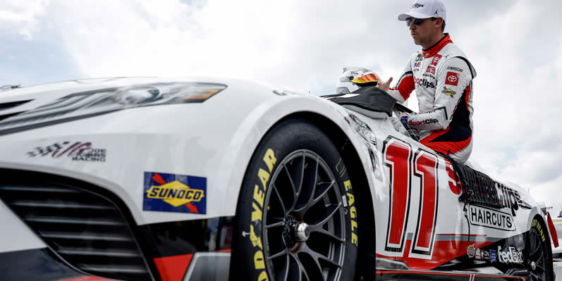 Denny Hamlin enters his car during qualifying