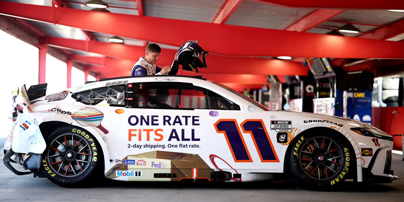 Denny Hamlin reacts in the garage area