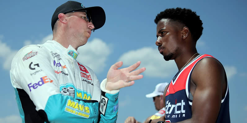 Denny Hamlin speaks to Rajah Caruth during qualifying