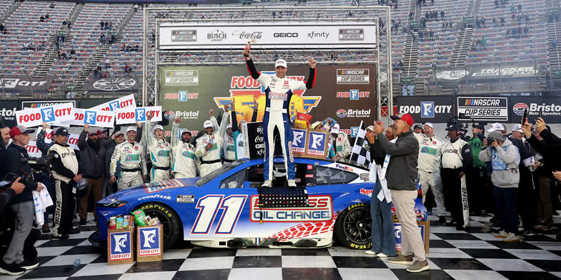 Denny Hamlin celebrates in victory lane