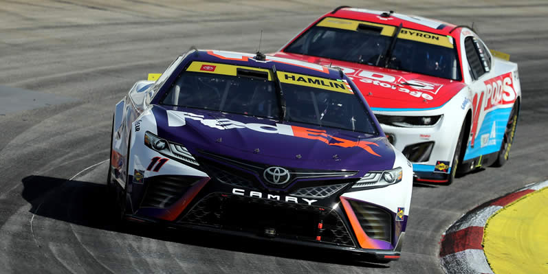 Denny Hamlin and William Byron drive during practice