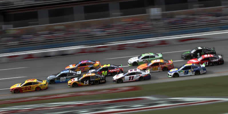 Joey Logano leads a pack of cars