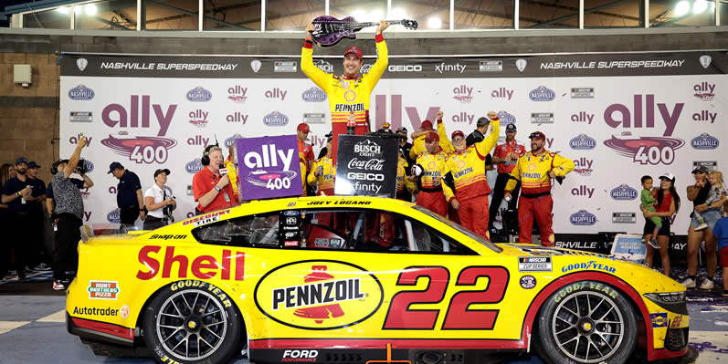 Joey Logano celebrates in victory lane