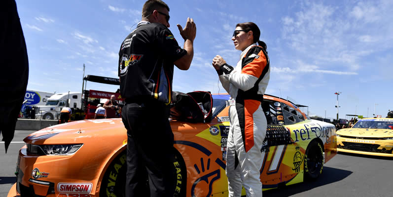 Katherine Legge speaks with a crew member