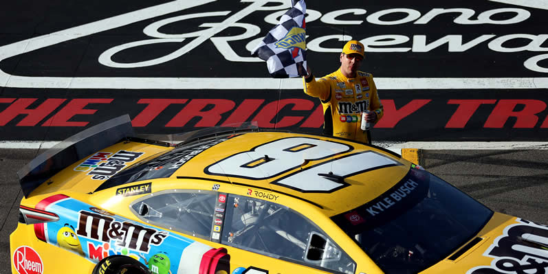 Kyle Busch celebrates with the checkered flag