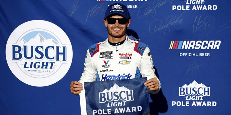 Kyle Larson poses for photos after winning the pole award