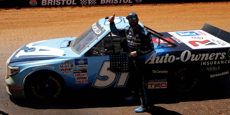 Martin Truex Jr gives a thumbs up to fans