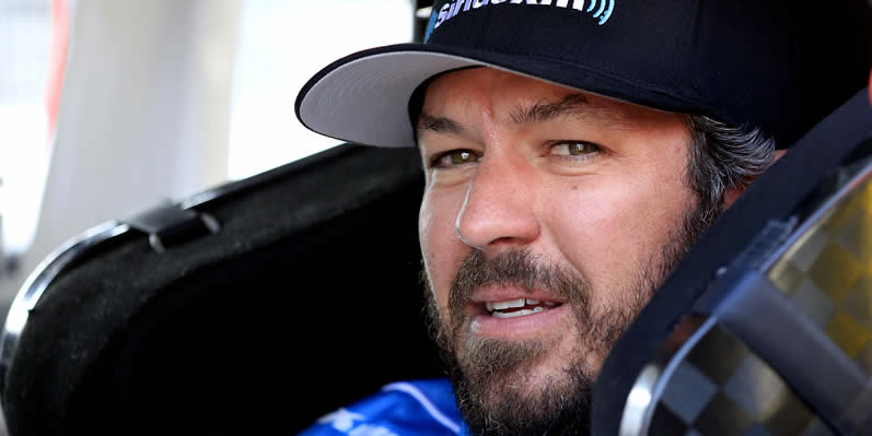 Martin Truex Jr sits in his car during qualifying