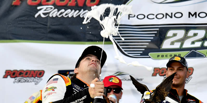 Noah Gragson celebrates with champagne in victory lane