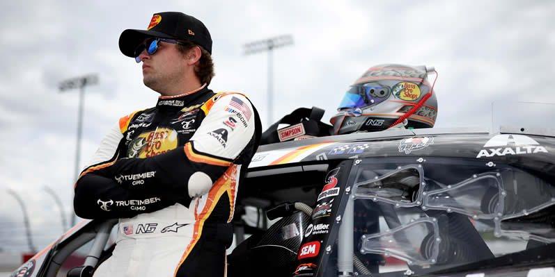 Noah Gragson leaning against his car