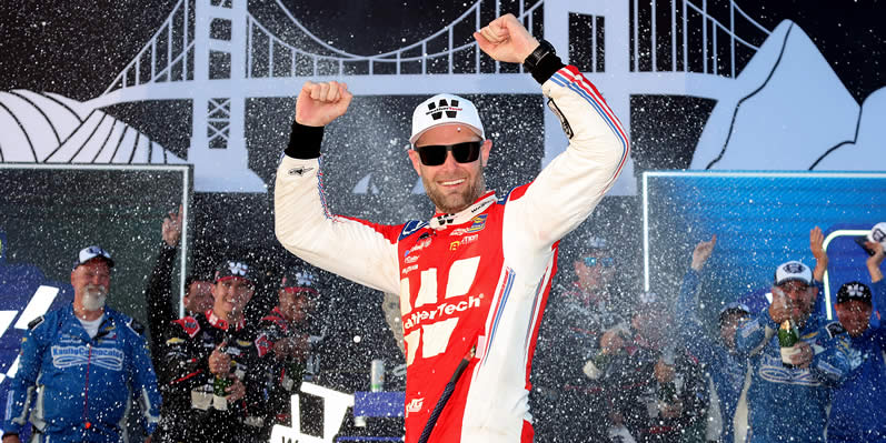 Shane Van Gisbergen celebrates in victory lane