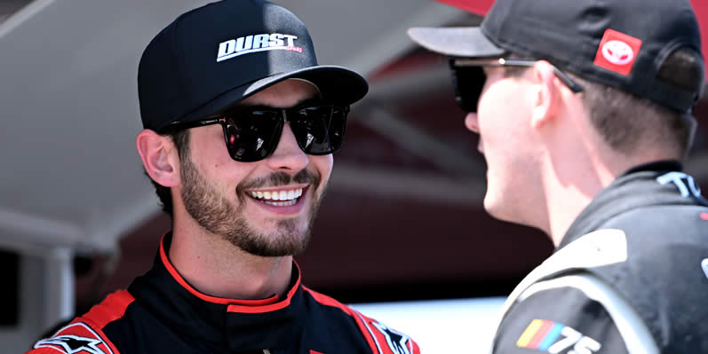 Tanner Gray and Taylor Gray talk on the grid during practice