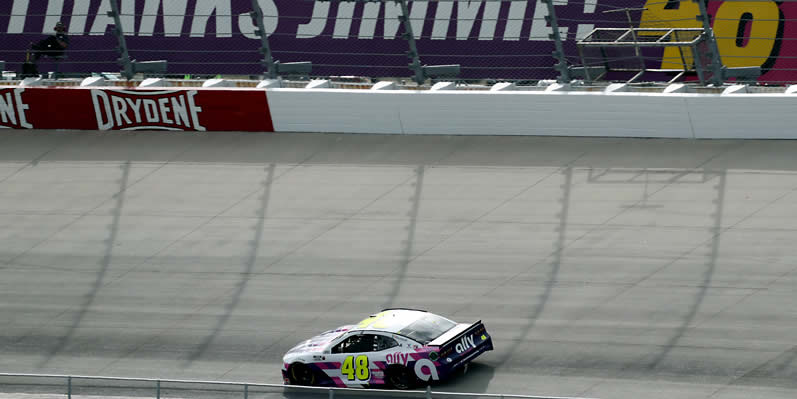 Jimmie Johnson races past a "Thanks Jimmie! 48 !" sign